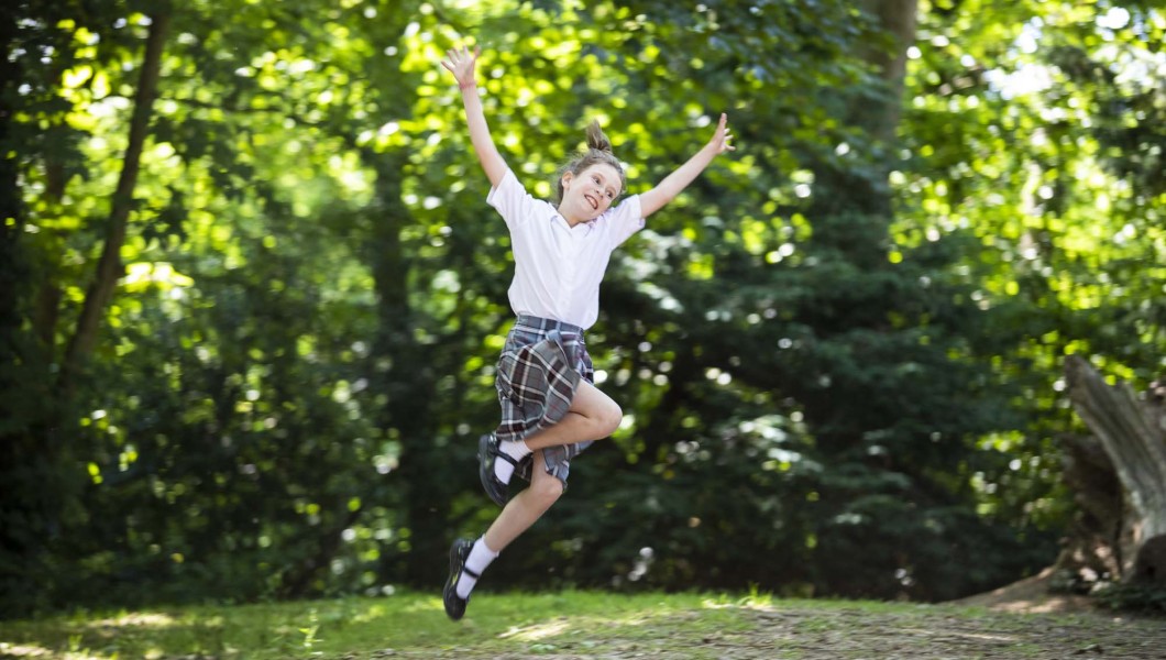 Girl jumping in woods