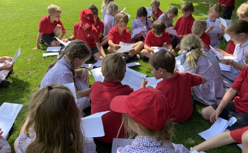 Year 2 sit down to open their buddy letters