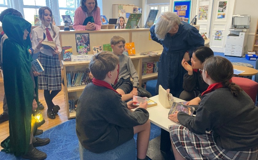 teacher and students sat with each other reading