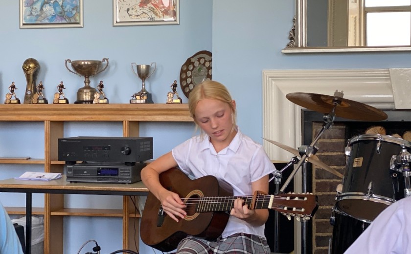 Individual performer playing guitar