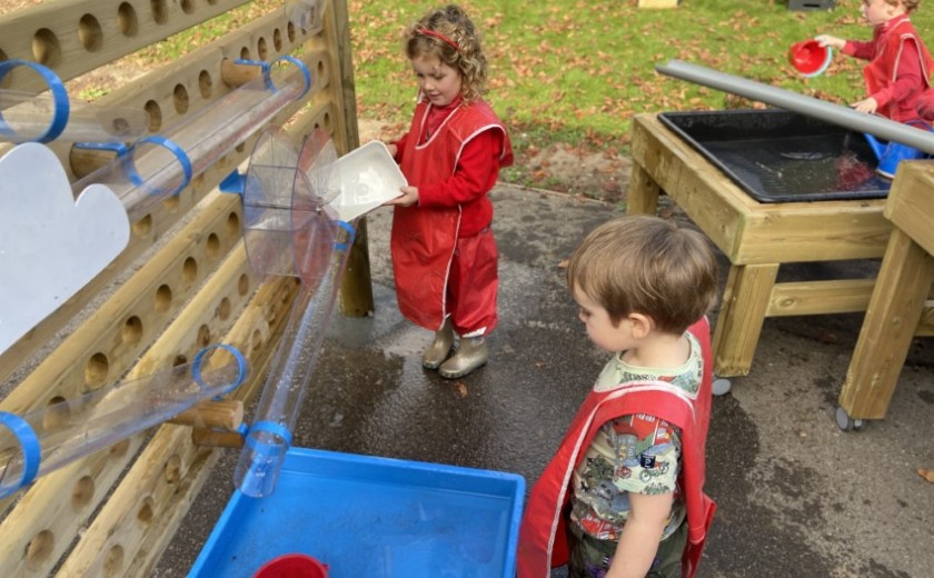 children play with water wall