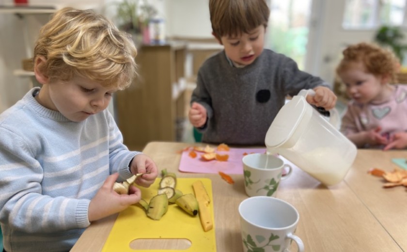 boy cuts up fruit for a snack