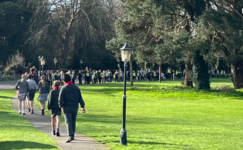 school children walking across the field