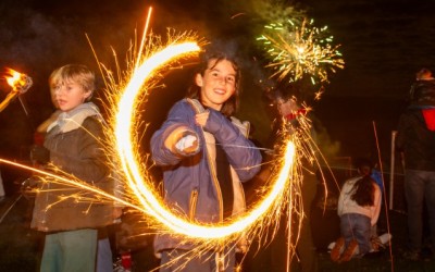 child makes a circle with a sparkler