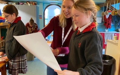 artist Victoria Heald with pupil looking at art work