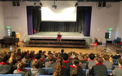 singer performing in front of school